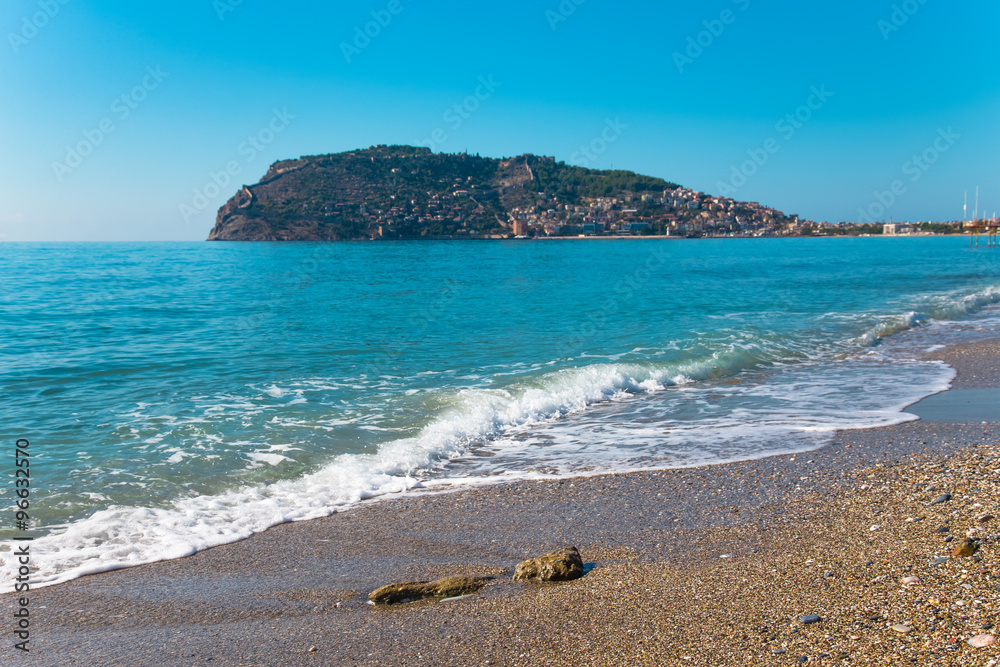 Wave on the beach and beautiful view to ancient fortress on the