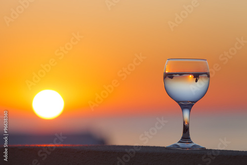 Glass of white vine with reflections of houses and view to beaut