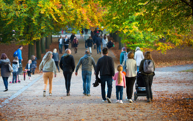 LONDON, UK - OCTOBER 31, 2015: Autumn in London park, people and families walking and enjoying the weather
