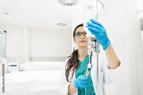 Wallpaper Mural Young woman doctor anesthesiologist dressed in green gown, puts Torontodigital.ca