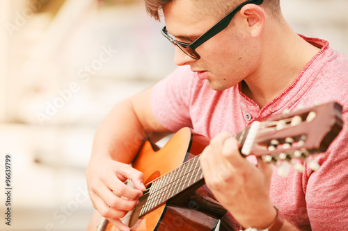 Trendy guy with guitar outdoor