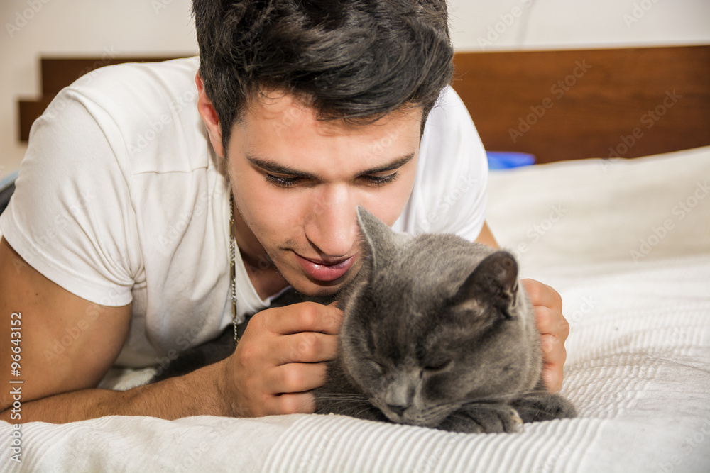 Handsome Young Man Cuddling his Gray Cat Pet Handsome Young Man Cuddling his Gray Cat Pet