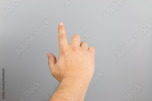 Man hand sign isolated on gray background
