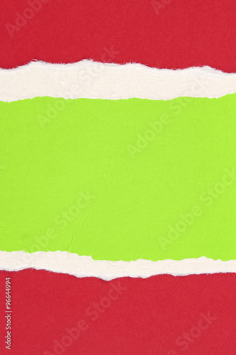 Ripped red paper on green background