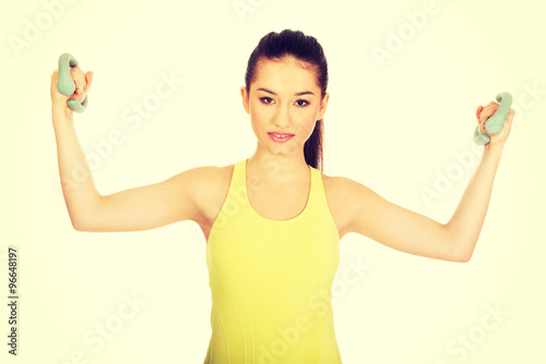 Active woman holding weights.