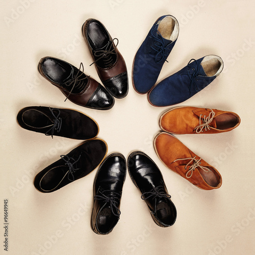 a lot of men s shoes.fashion still life men boots on paper background