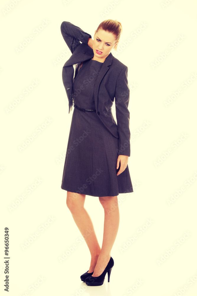 Businesswoman having neck pain.