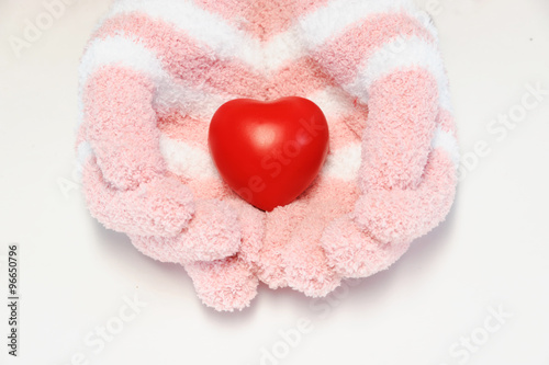 red heart in hands with gloves