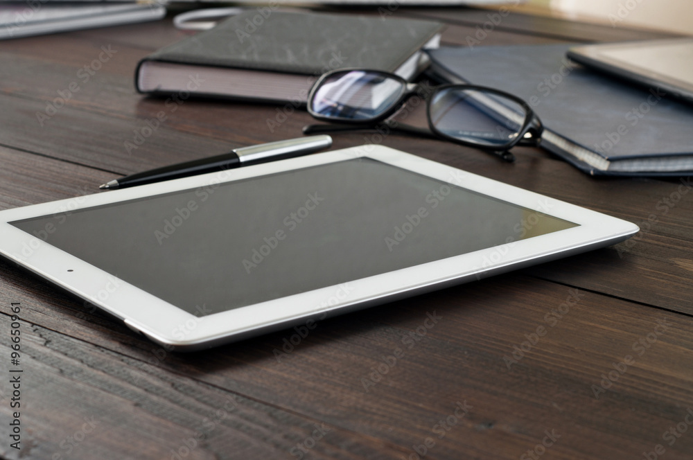 tablet computer on office wooden table