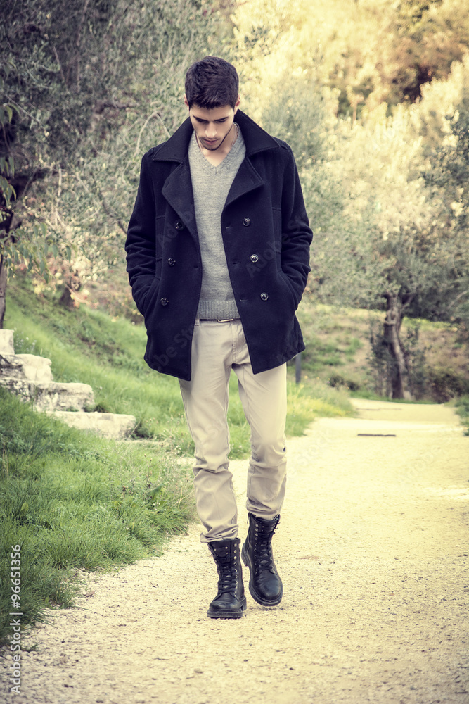 Handsome athletic young man hiking in park Handsome athletic young man hiking in park