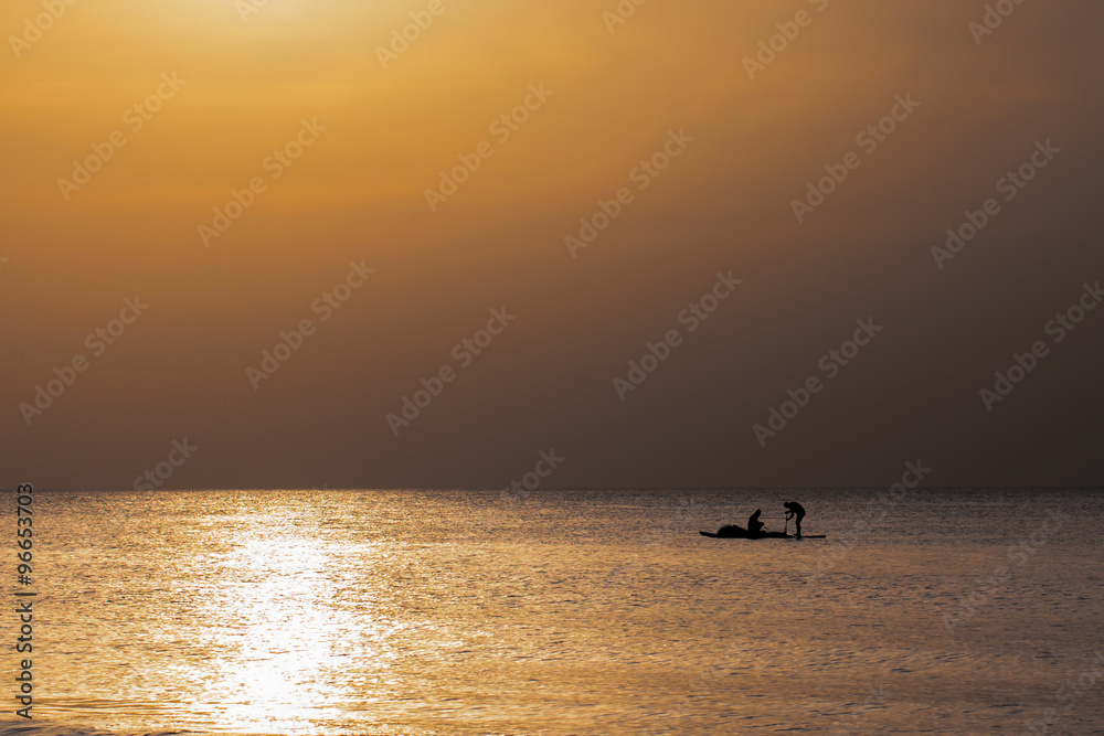 Golden sunset with fisherman boat