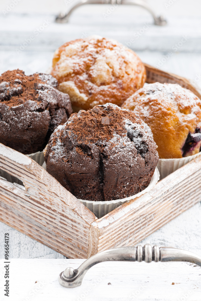 assortment of fresh delicious muffins, vertical