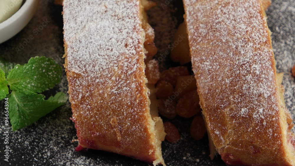 Apple pie (vienna strudel) with ice cream on black slate tray