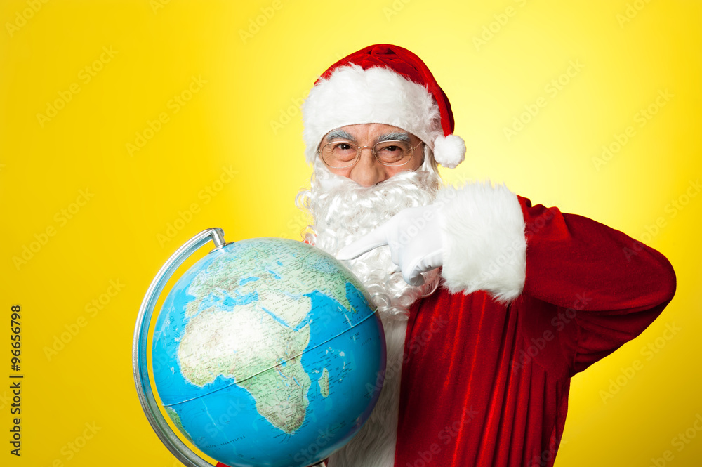 Ages man in santa costume holding globe Ages man in santa costume holding globe