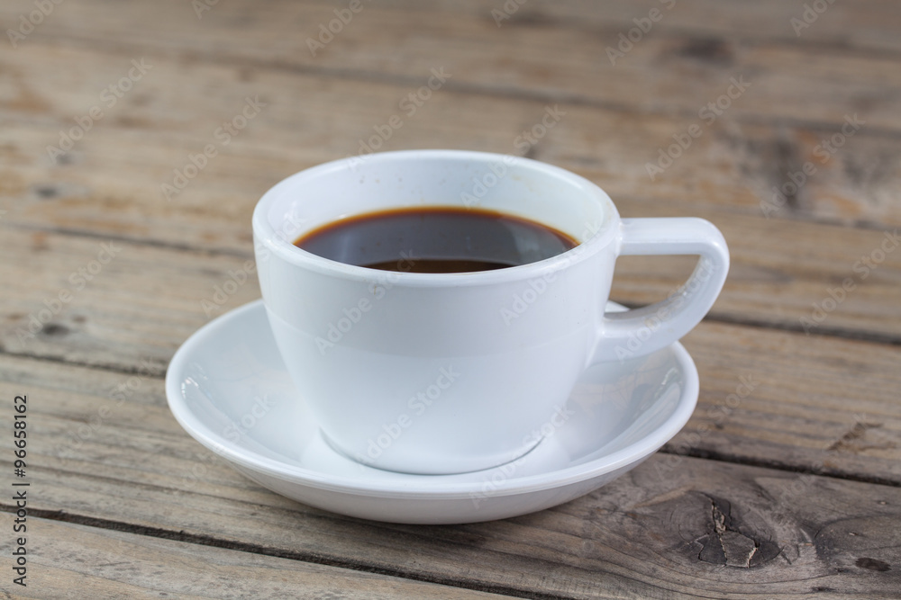 White cup of coffee on wood background White cup of coffee on wood background