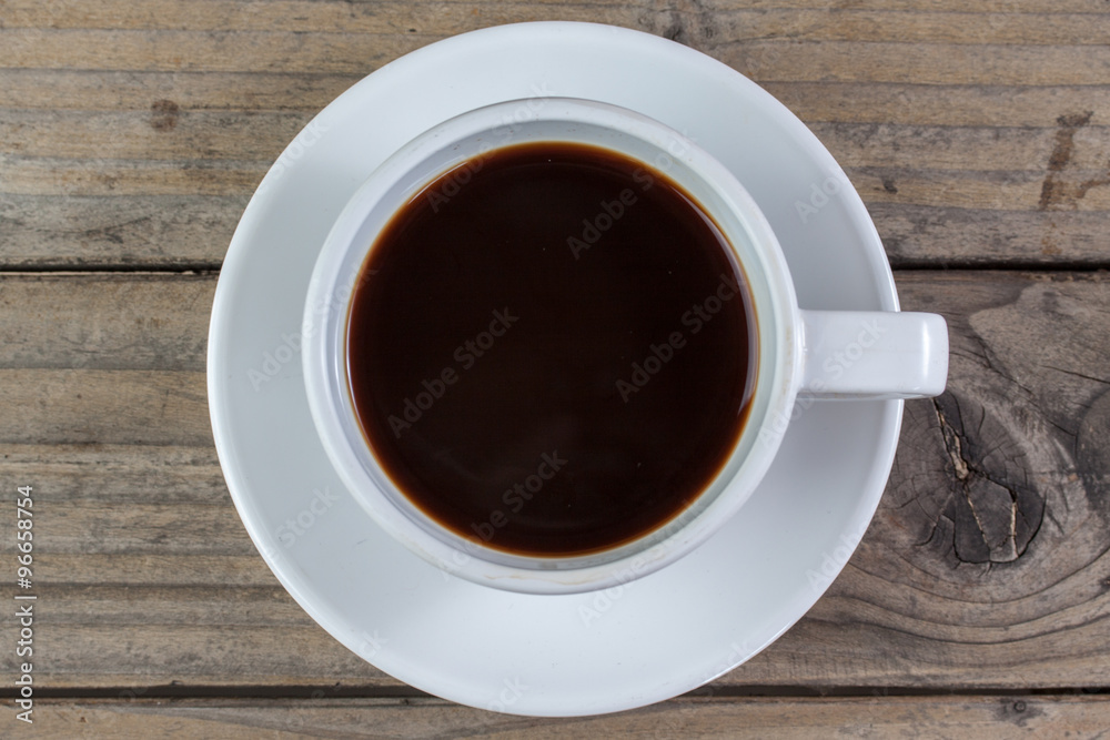 White cup of coffee on wood background White cup of coffee on wood background