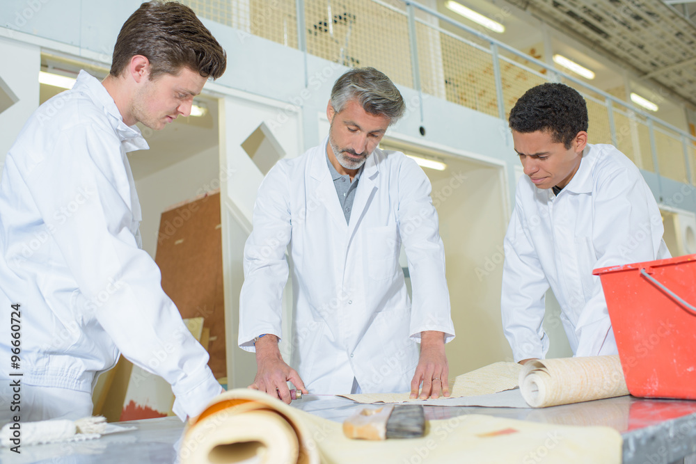Man teaching wallpapering Man teaching wallpapering