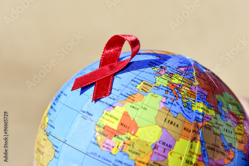 world globe with a red ribbon for the fight against AIDS photo