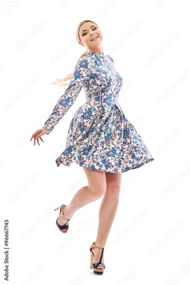 Long-haired blonde girl dancing in a beautiful blue dress. Long-haired blonde girl dancing in a beautiful blue dress.