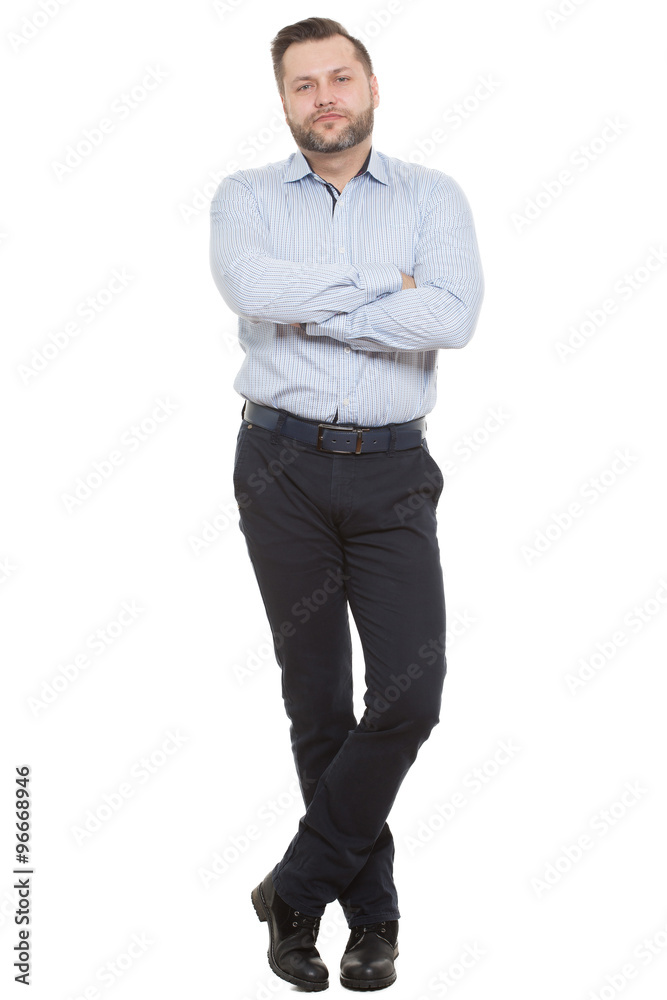 adult male with a beard. isolated on white background. Closed posture. arms  and legs crossed. body language Stock Photo
