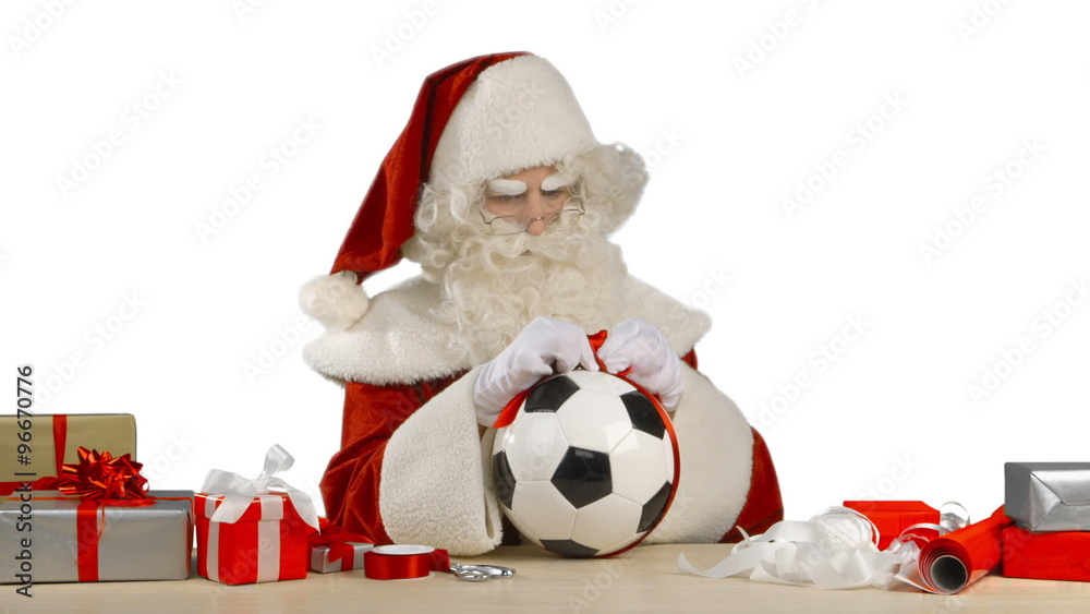 Santa Claus is Tying a Bow on a Soccer Ball