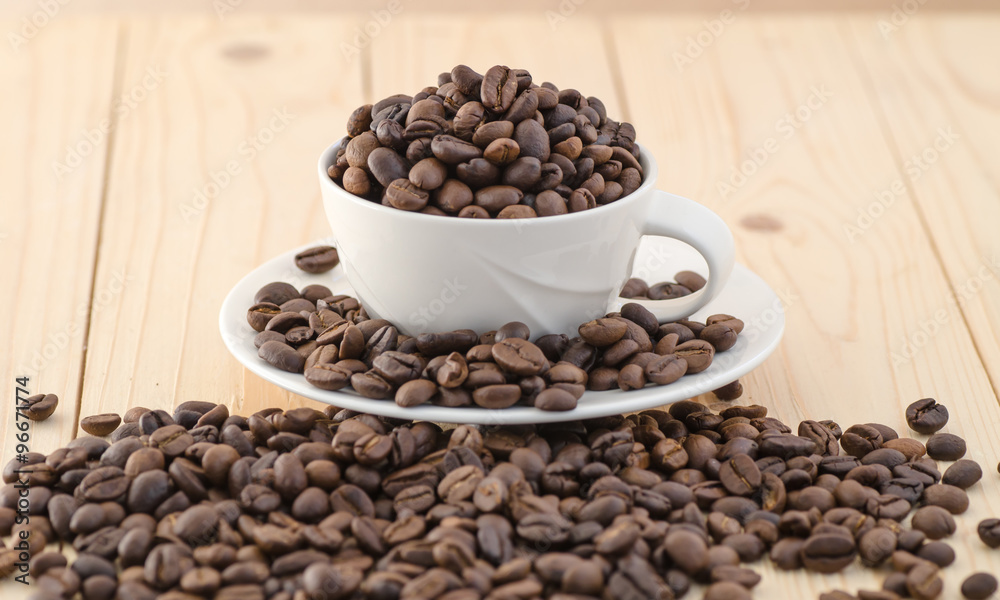 Fototapeta premium Cup of coffee full of coffee beans