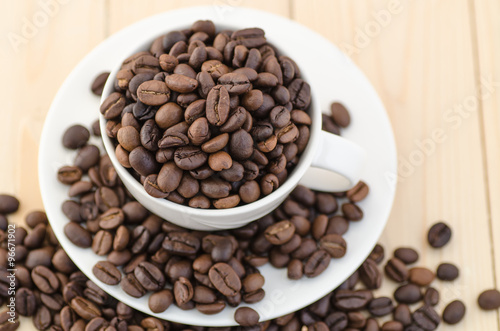 Cup of coffee full of coffee beans