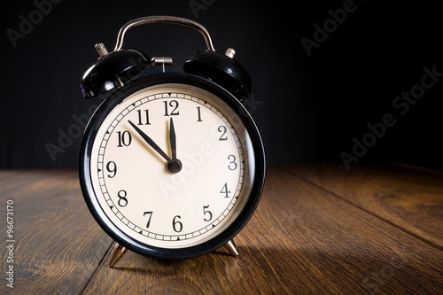 Alarm clock showing almost midnight. New year symbol.
