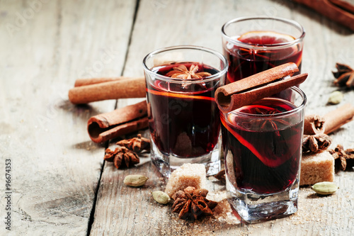 Winter hot mulled wine with cinnamon, star anise, orange and bro