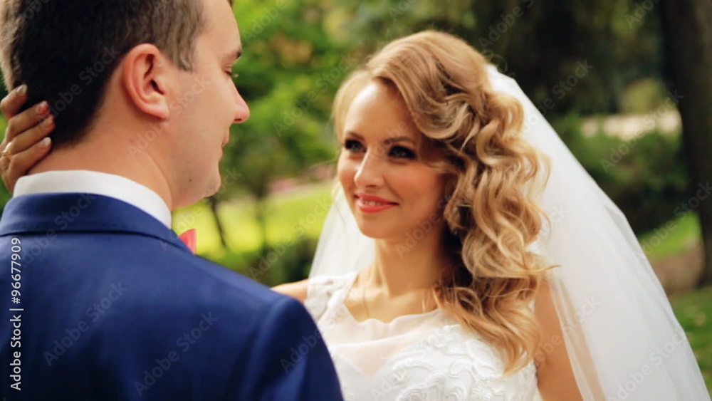 Bride and groom in love looking at each other at beautiful green park shot in slow motion close up Bride and groom in love looking at each other at beautiful green park shot in slow motion close up