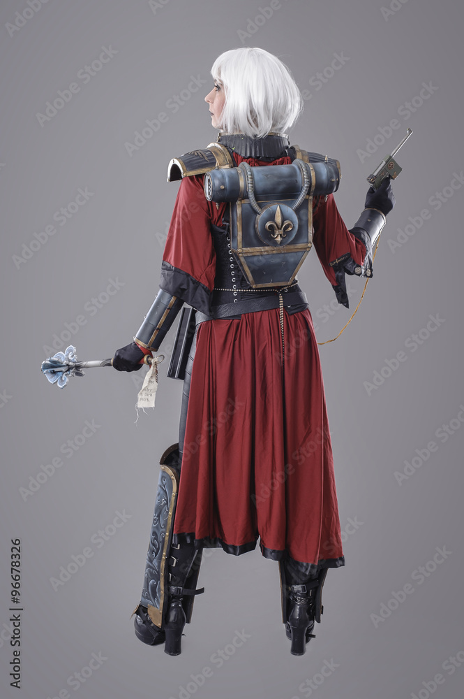 Fototapeta premium Woman warrior in battle armor. Isolated on the gray background