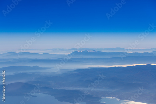 Deep blue sky above landscape with mountains and sea atmospheric aerial photography