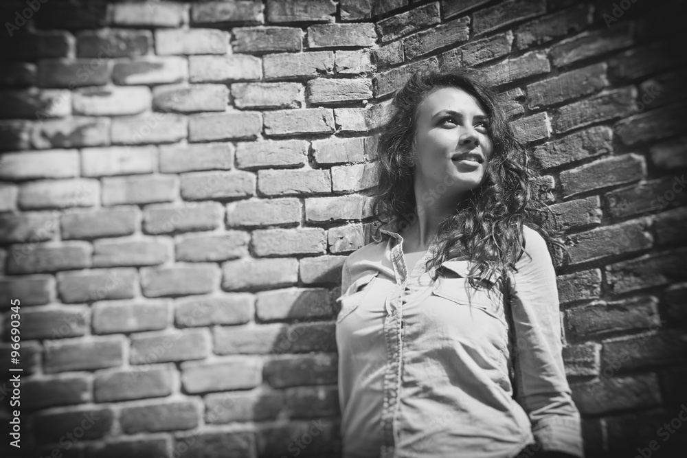 Girl leaning against a brick wall Girl leaning against a brick wall