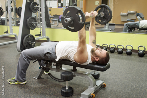 Man Doing E-Z Curl Bar Skullcrusher photo