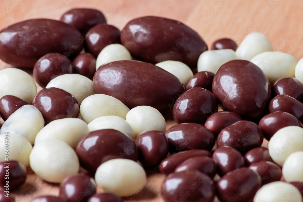 Chocolate dragee on wooden background. Chocolate dragee on wooden background.