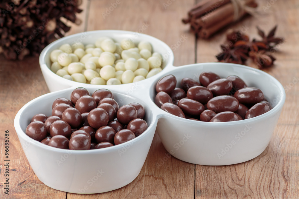Chocolate dragee in porcelain bowl Chocolate dragee in porcelain bowl