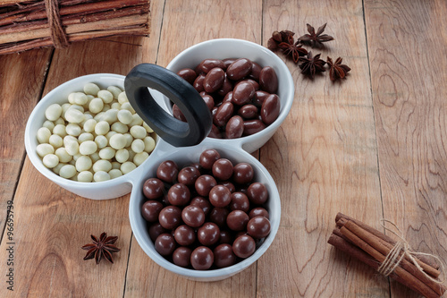 Chocolate dragee in porcelain bowl