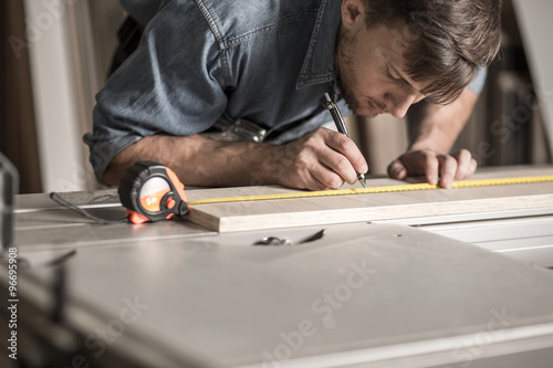 Precise young carpenter during work