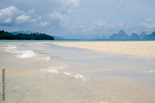 The quiet waves go in coral sands beach at Phang Nga Bay near Krabi and Phuket
