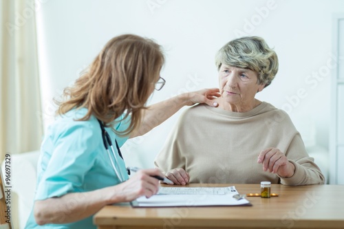 Doctor diagnosing elder woman