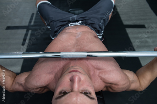 Muscular Man Doing Bench Press Exercise For Chest