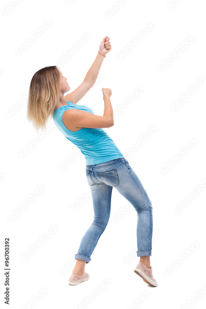 back view of standing girl pulling a rope from the top or cling back view of standing girl pulling a rope from the top or cling