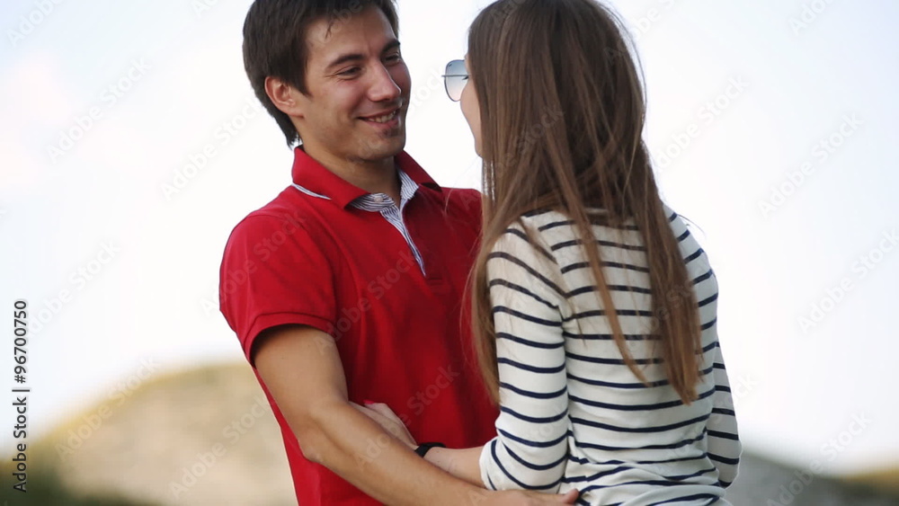 Young couple hugging and laughing in the mountains Young couple hugging and laughing in the mountains