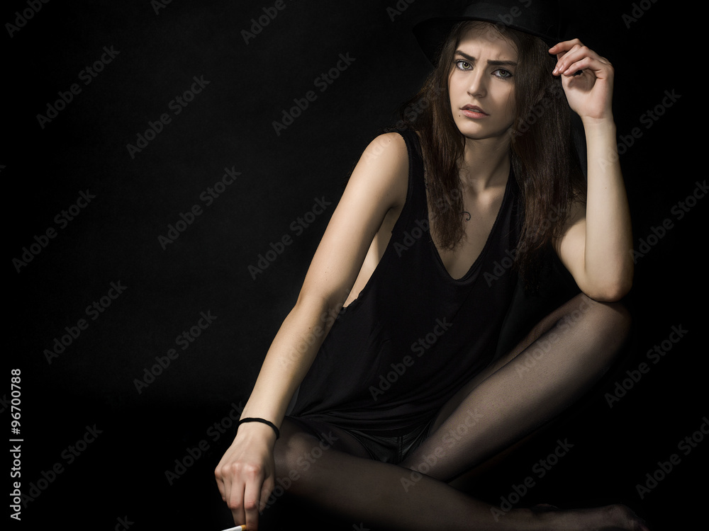 Beautiful girl portrait sitting and holding cigarette Beautiful girl portrait sitting and holding cigarette