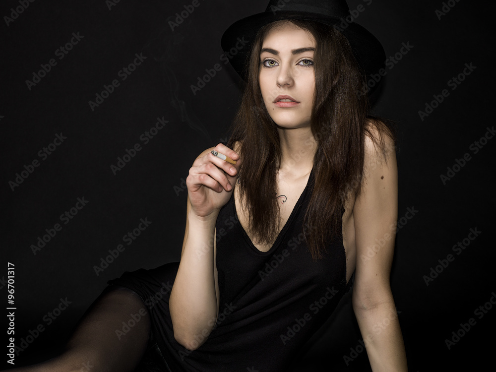 Pretty girl portrait with gorgeous eyes smoking cigarette Pretty girl portrait with gorgeous eyes smoking cigarette