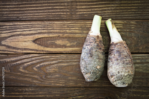 Fresh taro on wooden background.