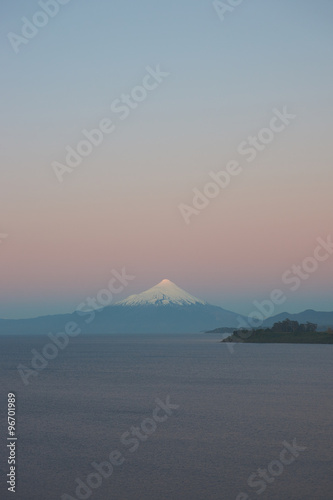 Sunset over Snow capped Volcano Osorno (2,652 metres) on the edge of Llanquihue Lake in Southern Chile. Viewed from Puerto Varas.