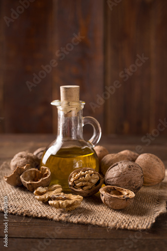 Walnut oil and nuts on wooden table