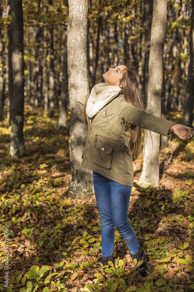 Fototapeta premium Portrait of a happy beautiful teenage girl enjoying the season