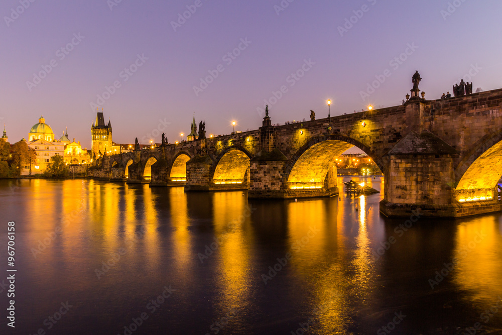 Fototapeta premium View at The Charles Bridge and Vltava river in Prague in dusk at sunset, Czech Republic